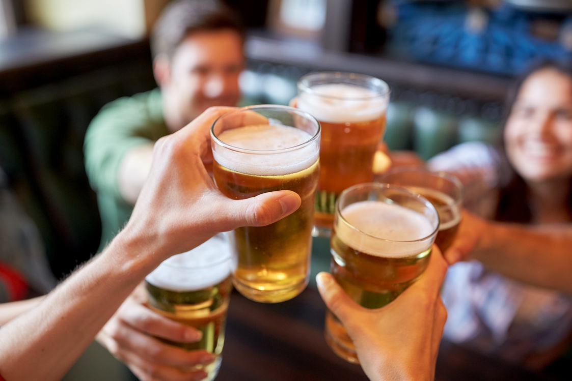 Happy Friends Drinking Beer at Bar